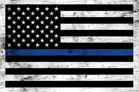 A police and law enforcement support flag stained over a weathered white wooden background.の写真素材