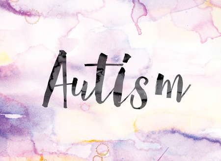 The word "Autism" painted in black ink over a colorful watercolor washed background concept and theme.の写真素材