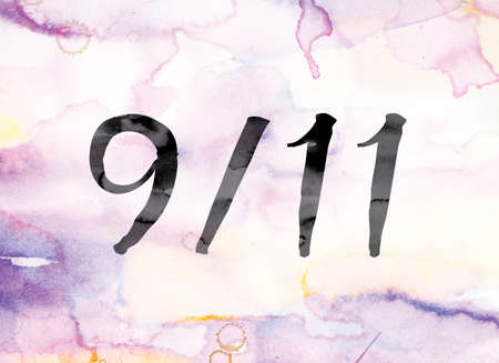 The word "9-11" painted in black ink over a colorful watercolor washed background concept and theme.の写真素材