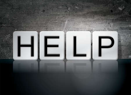 The word Help written in white tiles against a dark vintage grunge background.