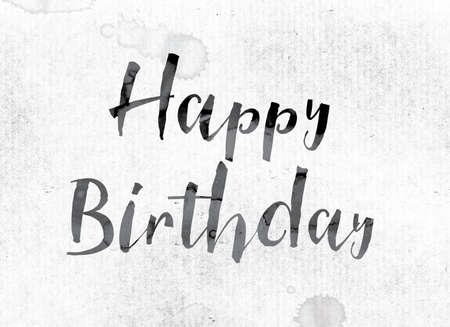 The word "Happy Birthday" concept and theme painted in watercolor ink on a white paper.の写真素材