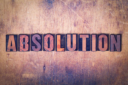 The word Absolution concept and theme written in vintage wooden letterpress type on a grunge...