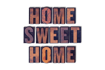 The words Home Sweet Home concept and theme written in vintage wooden letterpress type on a white background.の写真素材