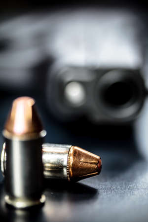 A black pistol hand gun with bullets.の写真素材