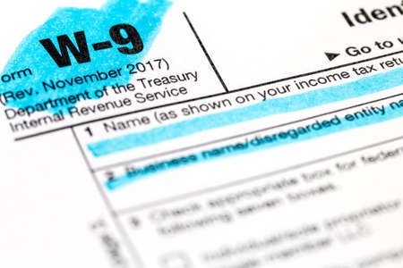 A macro closeup of a highlighted W9 federal income tax form.