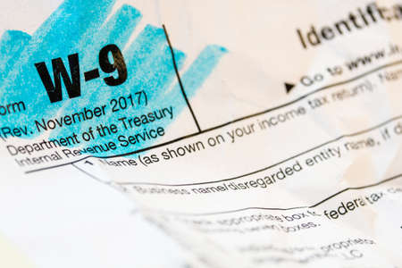 A macro closeup of a highlighted W9 federal income tax form.の写真素材