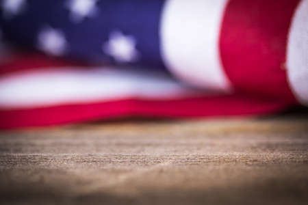 A vintage American flag on a wooden floor.の写真素材