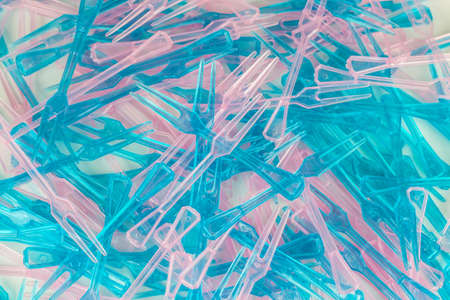 Set of two colored plastic forks on wooden background