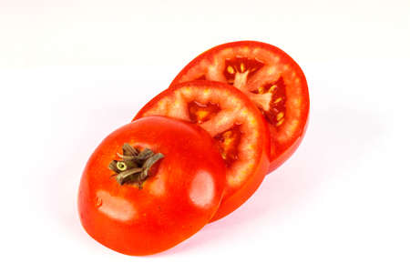 Tomato and slices of tomato on white background