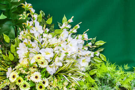 Bouquet of plastic flowers on a green backgroundの写真素材