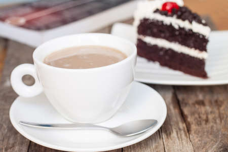 cup of coffee and chocolate cake on wood backgroundの写真素材