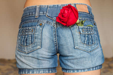 A rose in the back pocket of her jeans.の写真素材