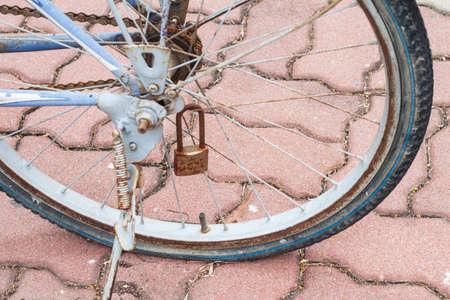 old rusty bicycles parked until flat wheelの写真素材