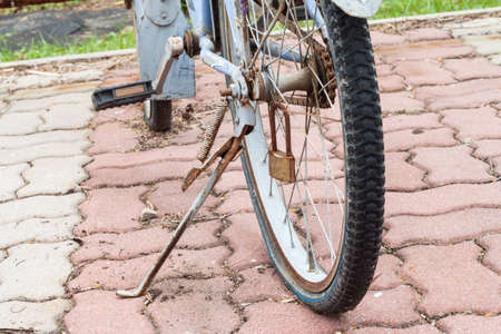 old rusty bicycles parked until flat wheelの写真素材