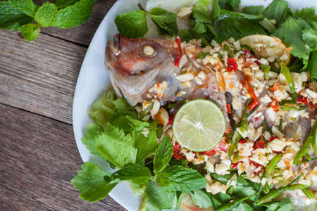 Steamed fish with lemon on the plateの写真素材