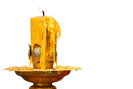 burning of candle on gold candlestick on white backgroundの写真素材