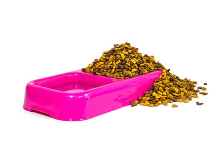dry cat food and water in pink bowl on white backgroundの写真素材