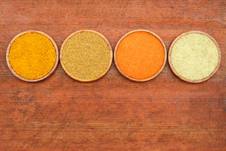 Various and herbs colorful spices on wooden tableの写真素材