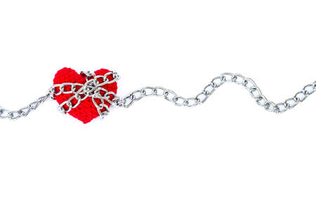 red heart shape entwined with chains on white background