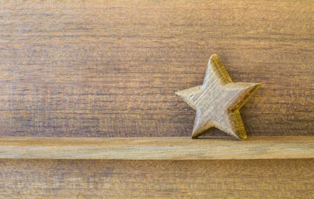 wood star on old wood shelf with copy space for your textの写真素材