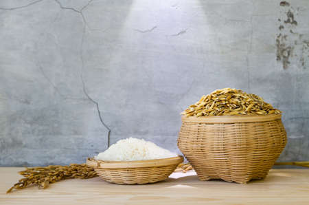 white rice or paddy rice on bamboo basket with cement wall backgroundの写真素材