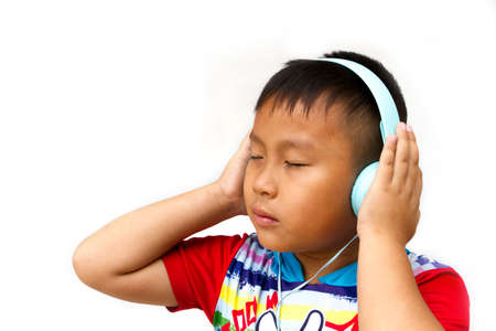 little boy wearing headphones isolated on white backgroundの写真素材