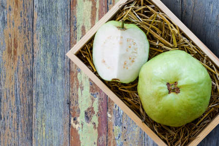 Fresh green goiaba on a wooden box