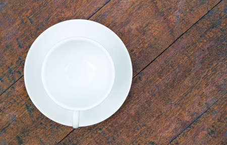 blank coffee cup top view on old wooden backgroundの写真素材