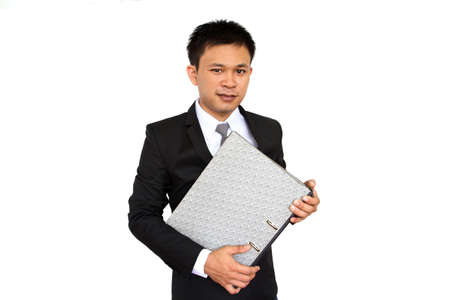 Portrait of young businessman holding folder isolated on white backgroundの写真素材