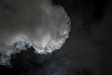 White smoke isolated on black backgroundの写真素材