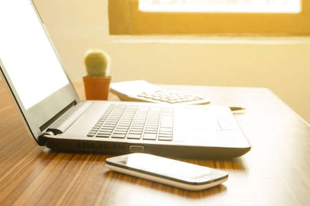 laptop with blank screen on desk in home