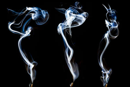 set of white smoke isolated on black backgroundの写真素材