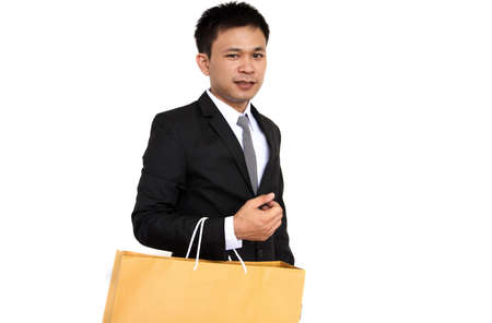 Businessman holding paper bag isolated on white backgroundの写真素材