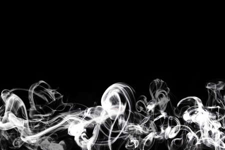 white smoke isolated on black backgroundの写真素材