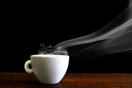 white coffee cup with steam on the wooden tableの写真素材