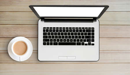 laptop and coffee on old wooden desk.の写真素材