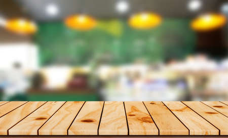 Wood shelf on blurred coffee shop background for product display montageの写真素材