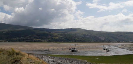 Tide out in Snowdonia with beached boatsの写真素材