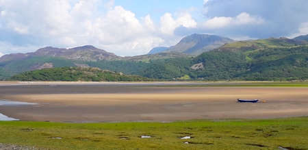 Tide out in Snowdonia with beached boatの写真素材