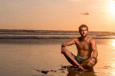 Sexy man on the beach enjoying summer holidayの写真素材