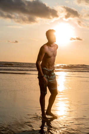 Sexy man on the beach enjoying summer holidayの写真素材