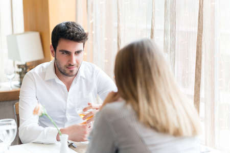 food, christmas, holidays and people concept - smiling couple eating main course at restaurantの写真素材