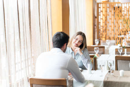 food, christmas, holidays and people concept - smiling couple eating main course at restaurantの写真素材