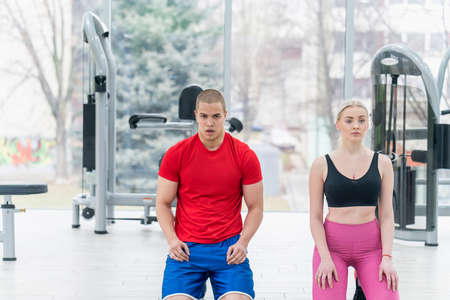 sport, fitness, weightlifting and training concept - group of people with kettlebells exercising in gymの写真素材
