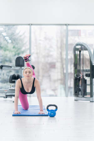 Woman Kettlebell training in gymの写真素材
