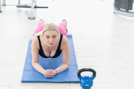Woman Kettlebell training in gymの写真素材
