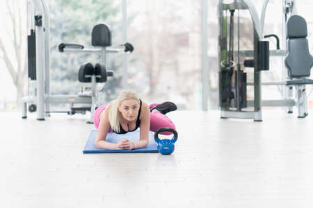 Woman Kettlebell training in gymの写真素材
