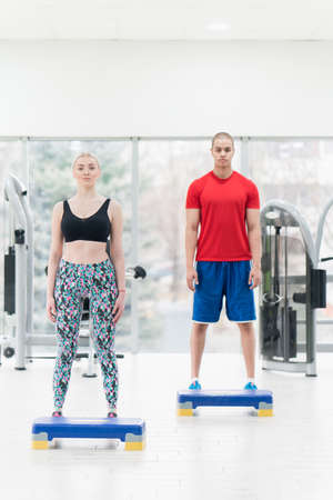 Young couple exercising stretching together. Young man and woman stretching.の写真素材