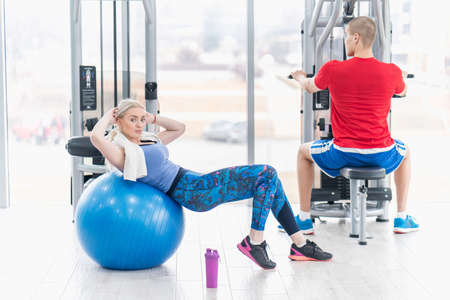 Fitness couple in the gym workoutの写真素材