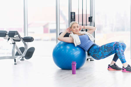 Young woman girl exercise workout in the gym using ballの写真素材